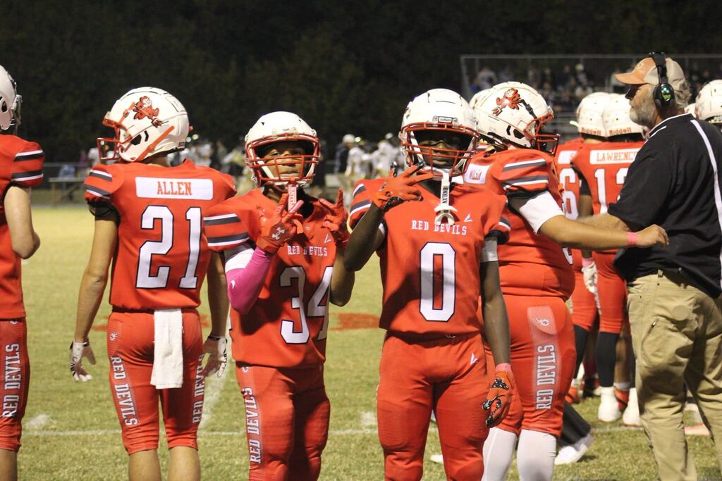 Two South Fulton High School football players pose for the camera between plays during the football game.