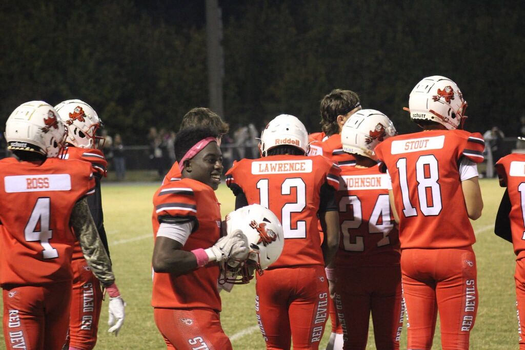 A South Fulton High School football player smiles while in the huddle.