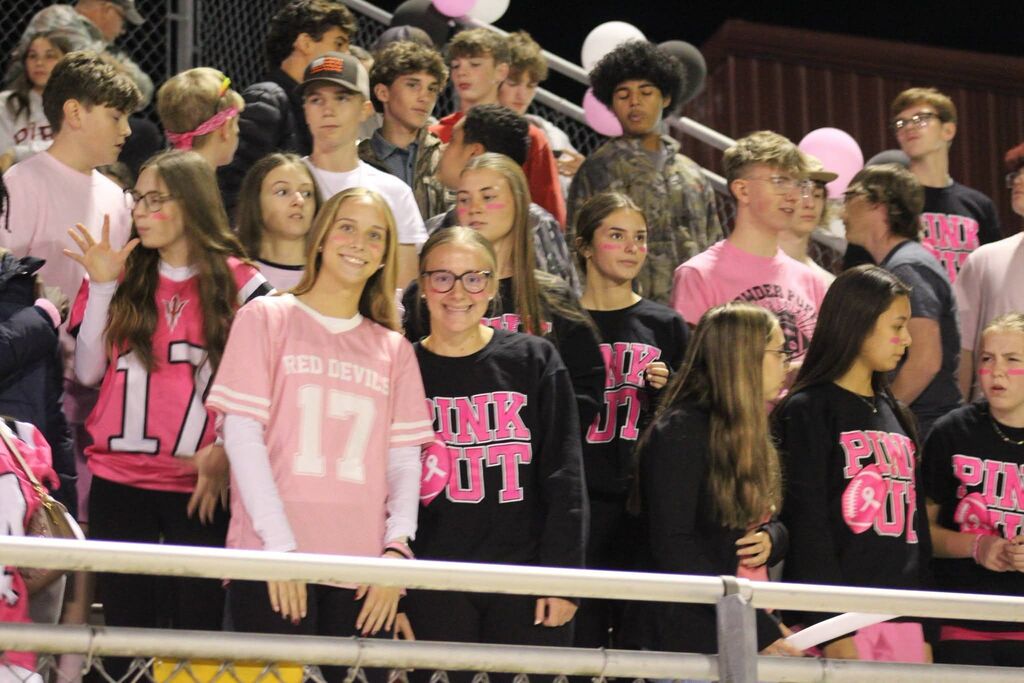 Two of South Fulton High School's Pep Club members smile from the stands during the football game.