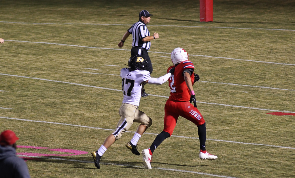 A South Fulton High School football player runs the ball while trying to dodge a defender from Dresden.