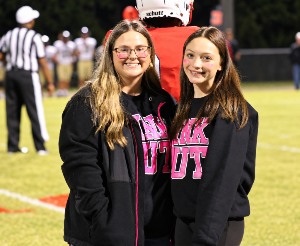 Two South Fulton High School students smile for the camera while wearing pink out shirts.