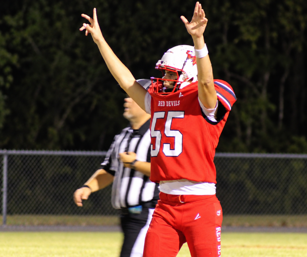 A South Fulton High School football player raises his arms in celebration during football game.