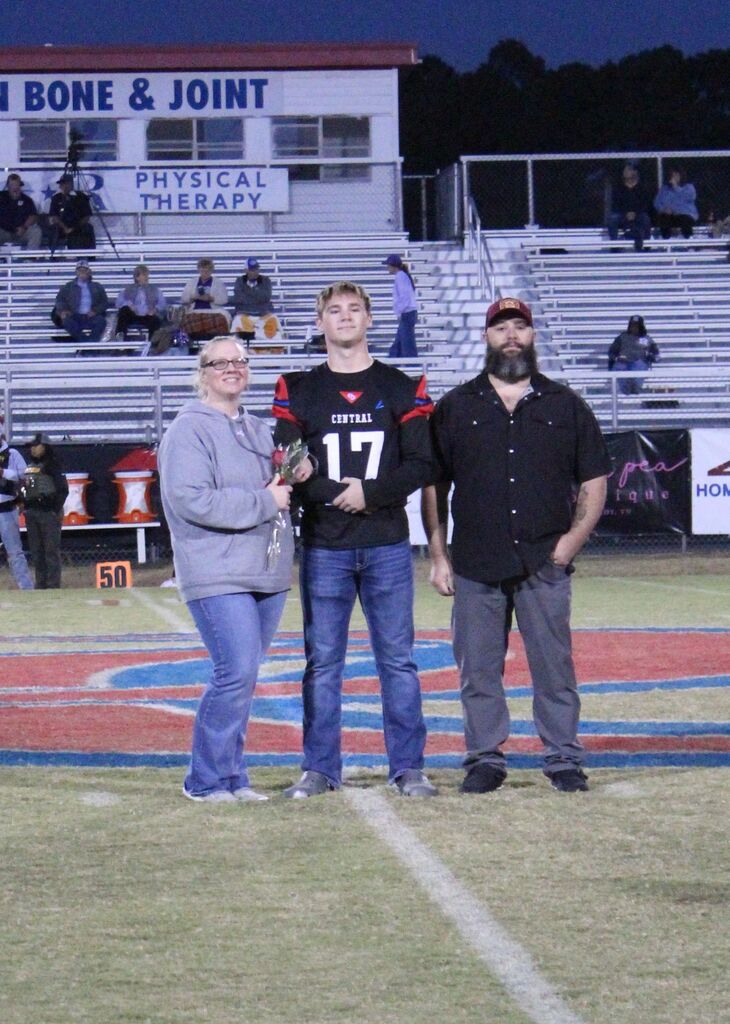 OCCHS Football senior and family smile for the camera.