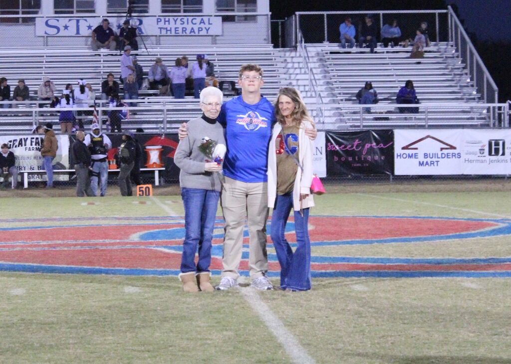 OCCHS Football senior and family smile for the camera.