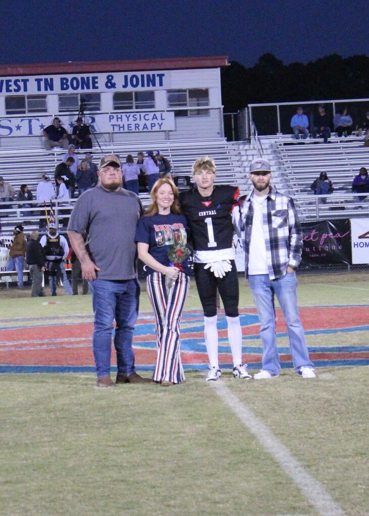 OCCHS Football senior and family smile for the camera.