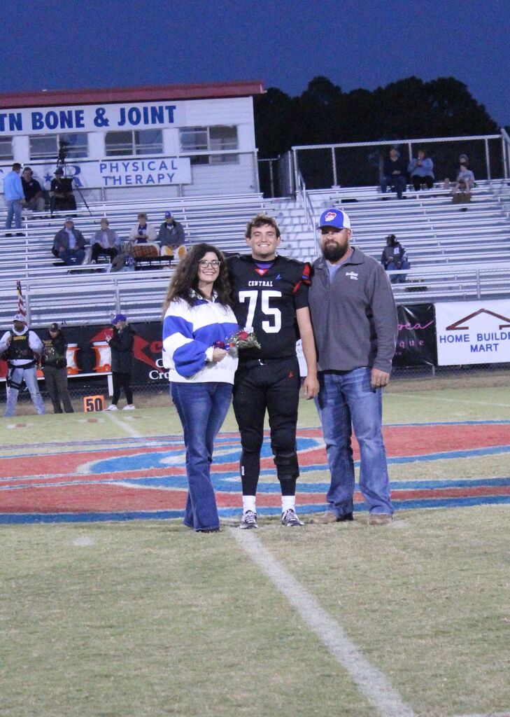 OCCHS Football senior and family smile for the camera.