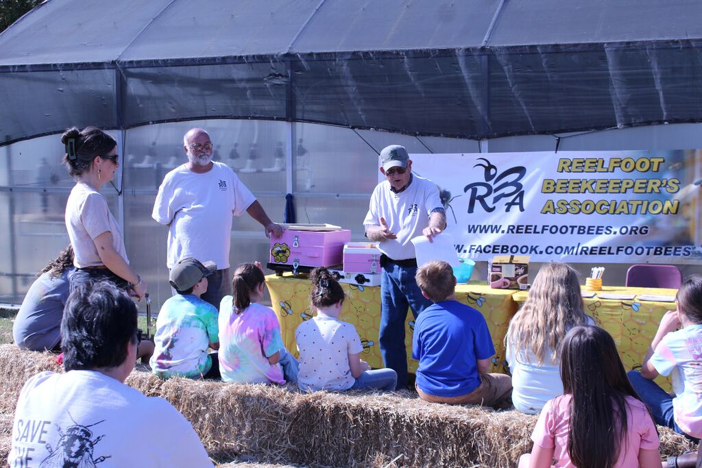 A presenter tells about bees to a group of students.