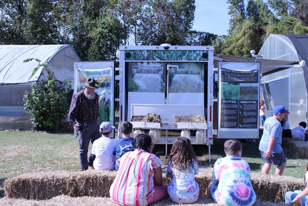 A presenter tells about soil conservation to a group of students.