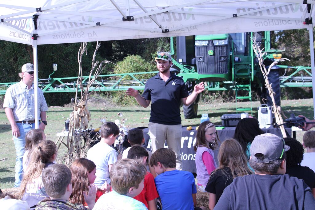 A group of students listen to an agriculture presenter at OCCHS Farm Day.