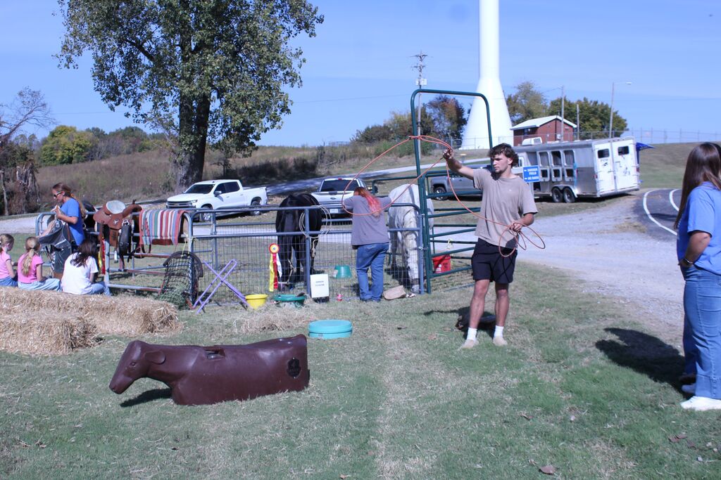 An OCCHS FFA student demonstrates how to rope a cow.