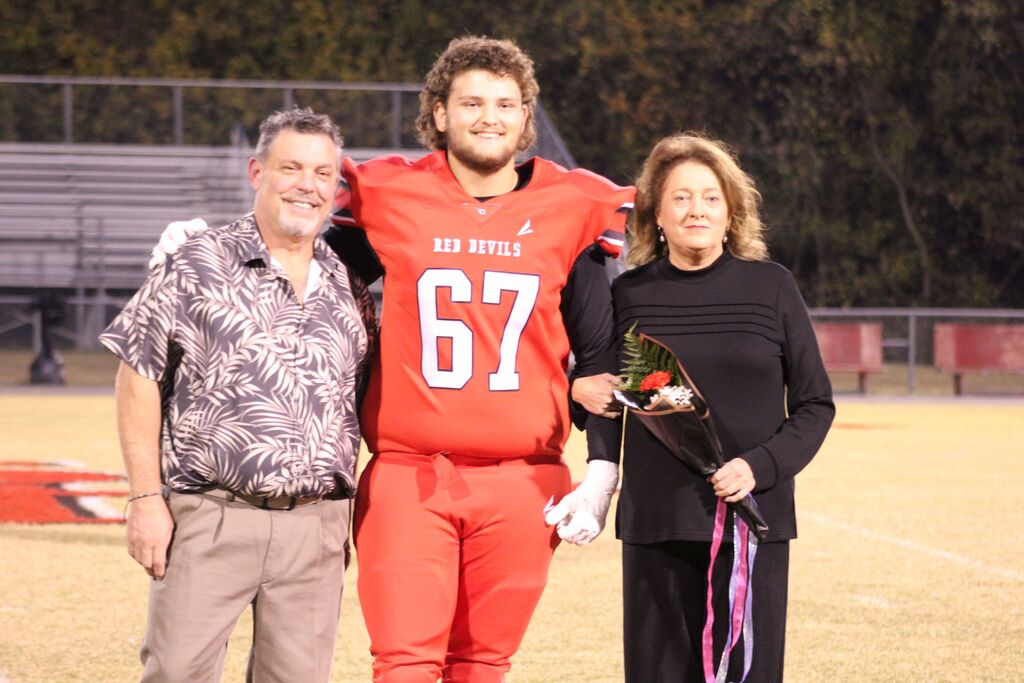 A South Fulton football player and family smile for the camera.
