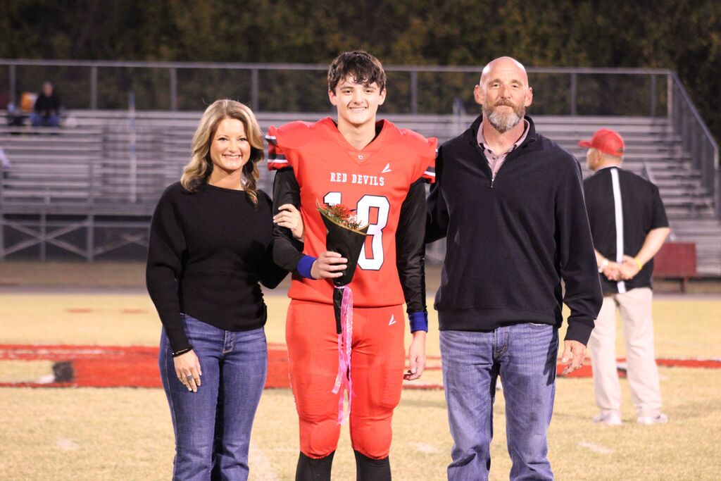 A South Fulton football player and family smile for the camera.