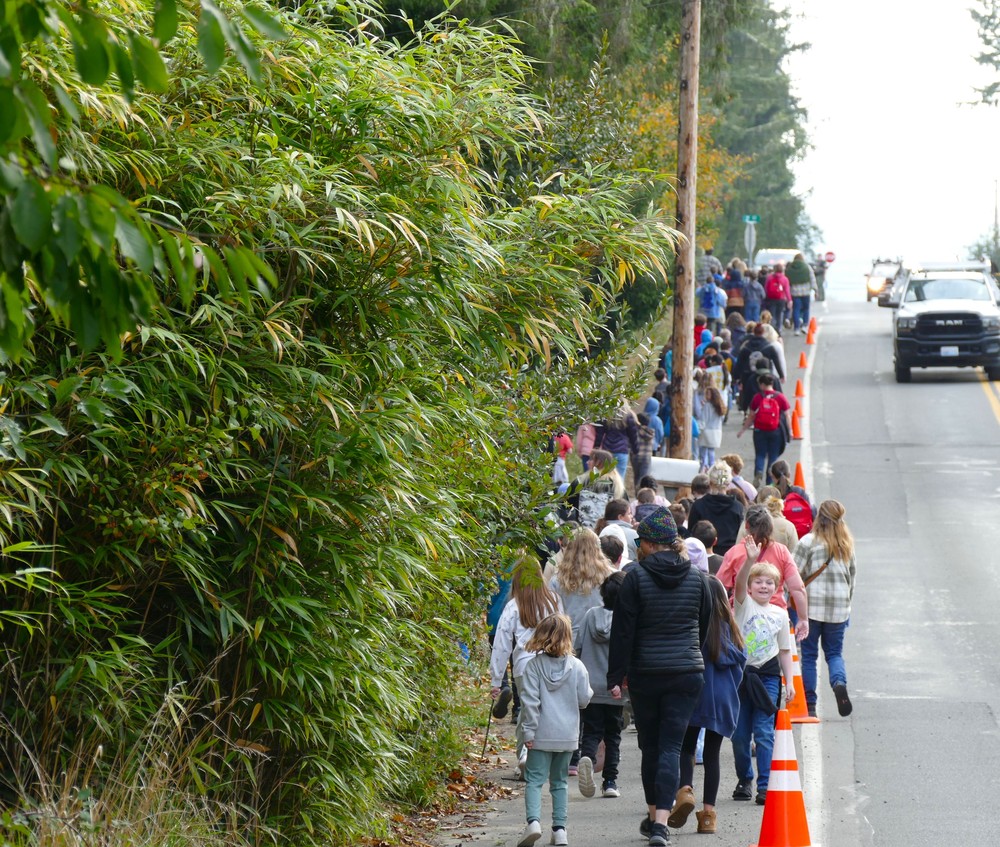 Students and staff walking on the sidewalk