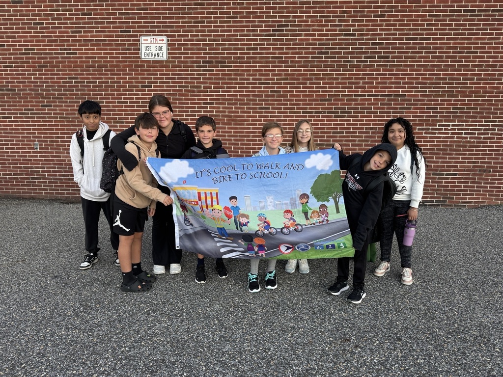 Ocean City Intermediate School students display a banner promoting safe travel habits to celebrate National Walk & Roll to School Day