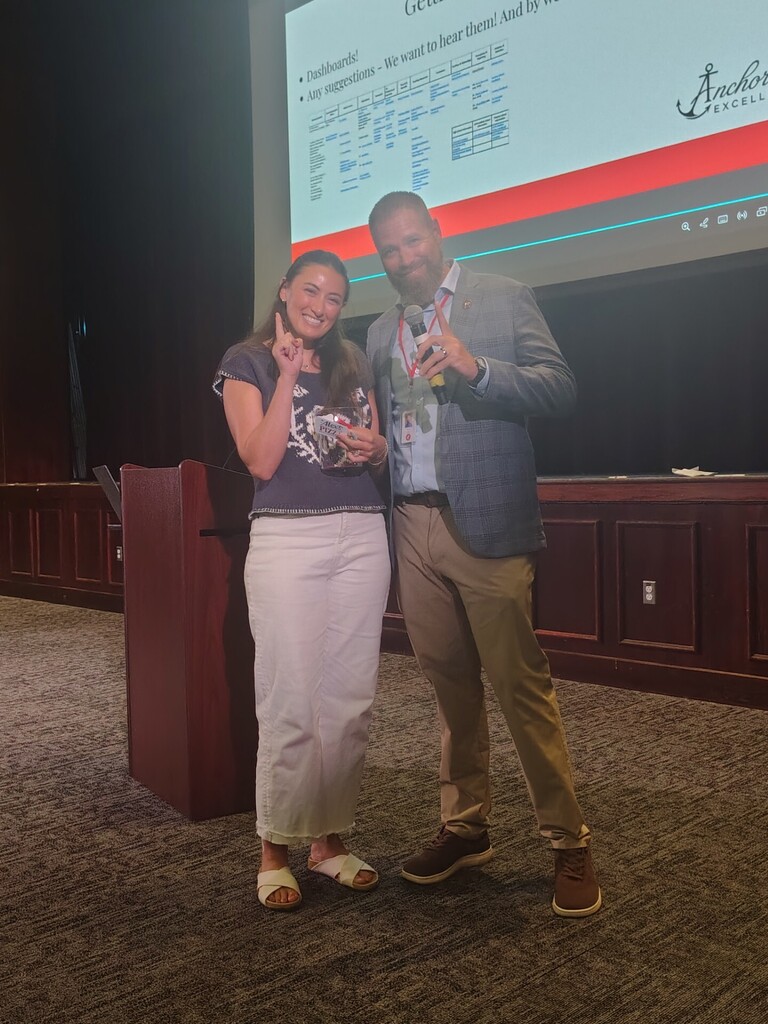 superintendent and teacher holding number one winner for raffle