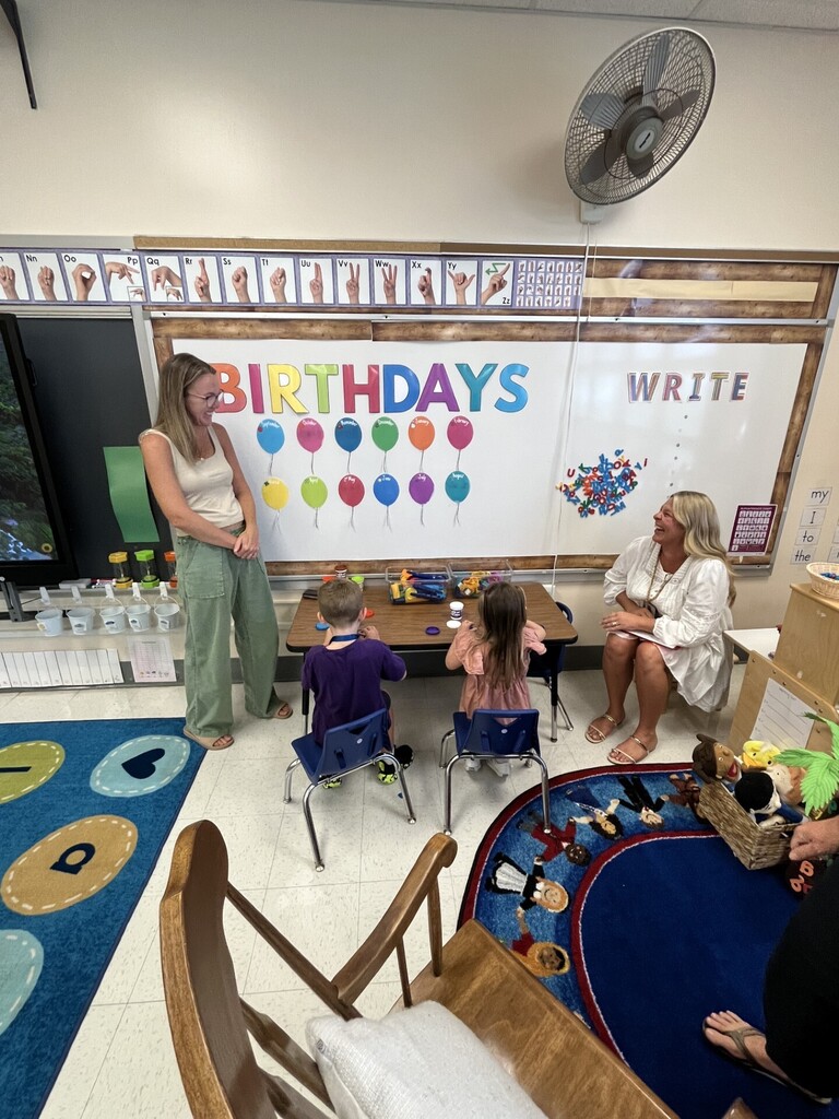 preschool students sitting with teachers