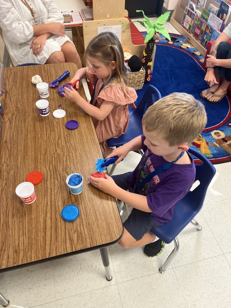 preschool students playing with playdoe