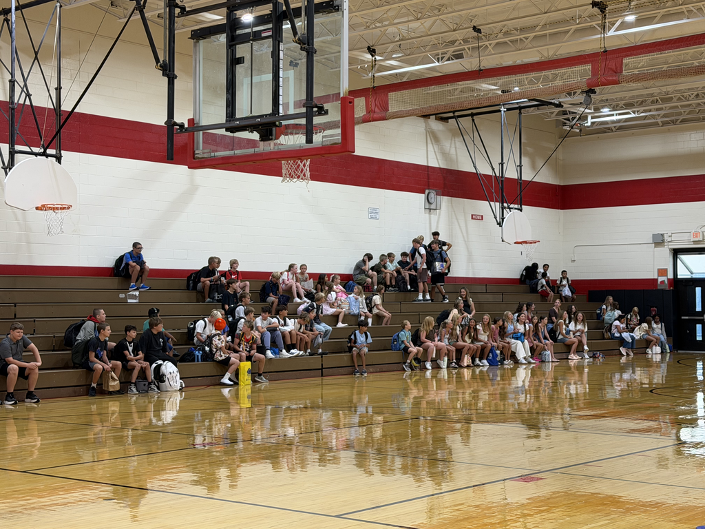 OCIS Gym and students sitting on bleachers