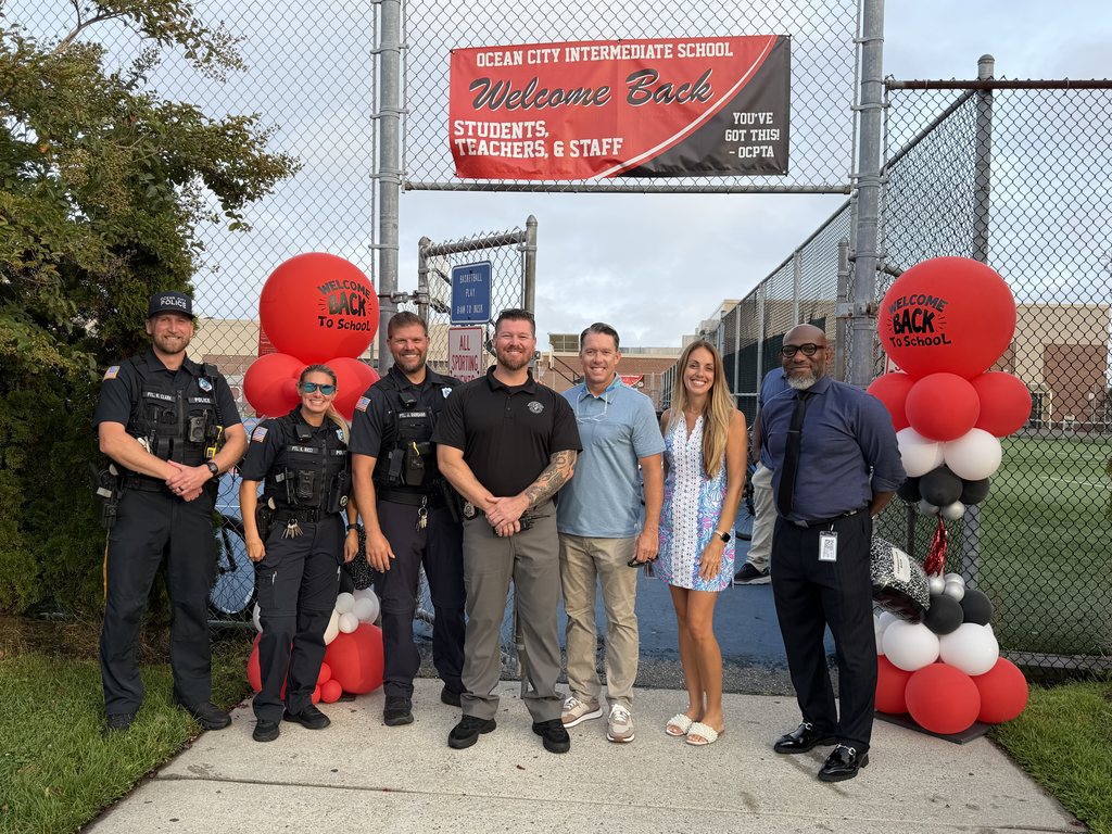 staff with local law enforcement posing for a photo