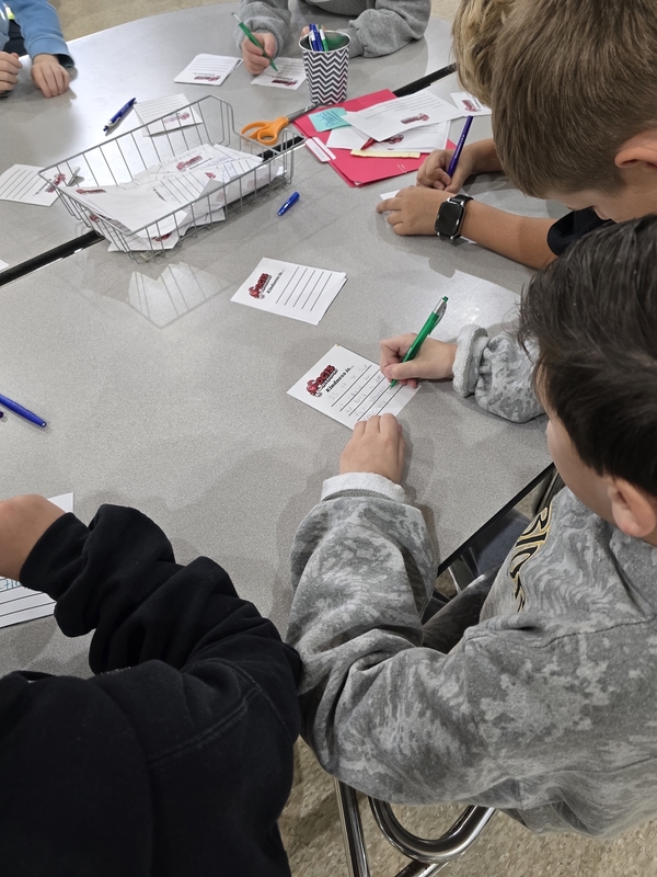 OCIS students (above) donated and delivered more than 500 items to a local humane society as part of the Student Council’s Santa Paws drive. Below, OCIS students sign anti-bullying pledges during New Jersey’s Week of Respect. 
