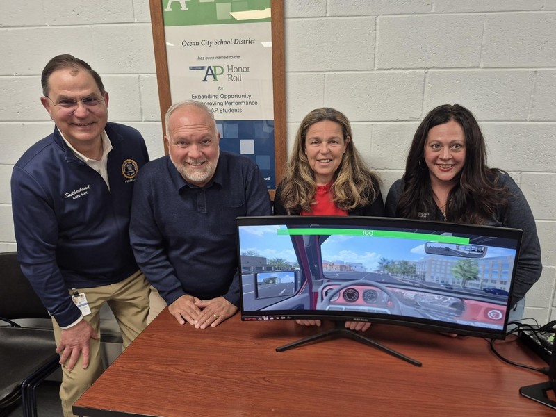OCSD admin and local officials post with driving simulator