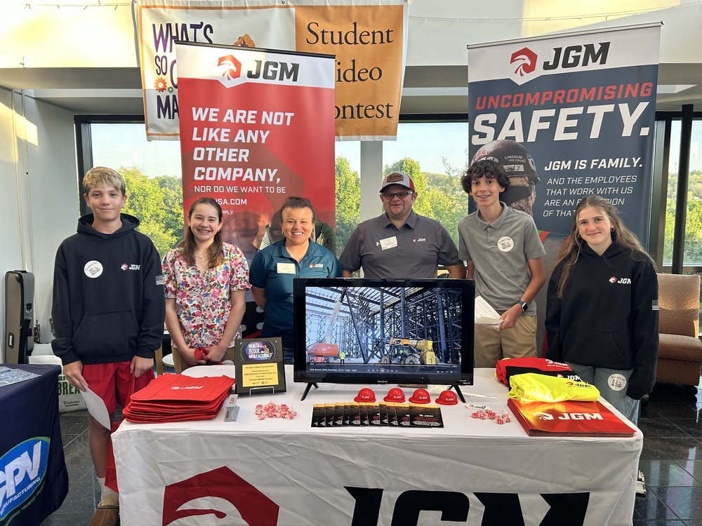 students stand with JPM employees smiling 