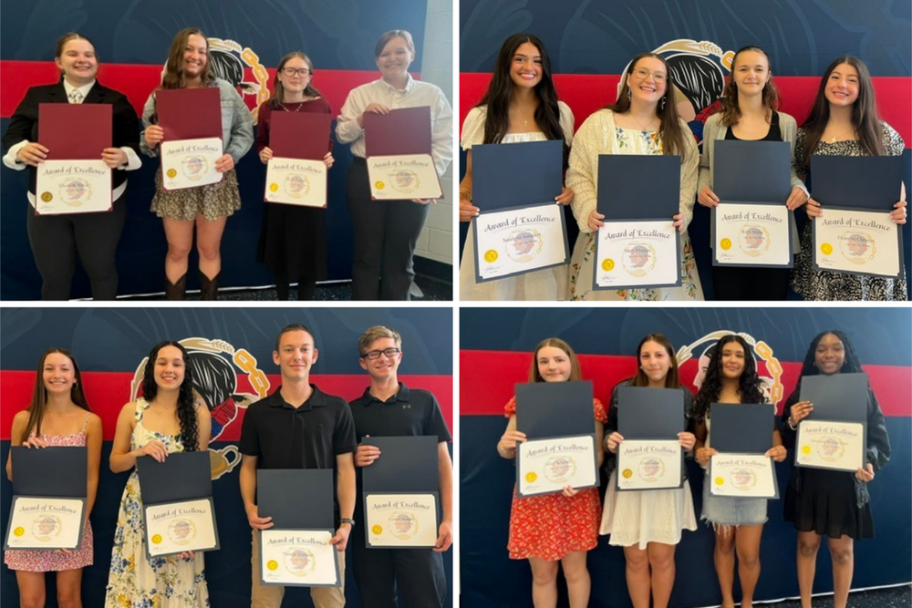 12 students hold a certificate and smile
