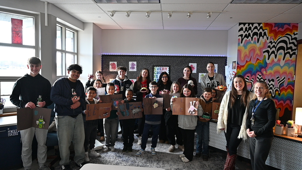 OHS and OIS students posing with their art projects.