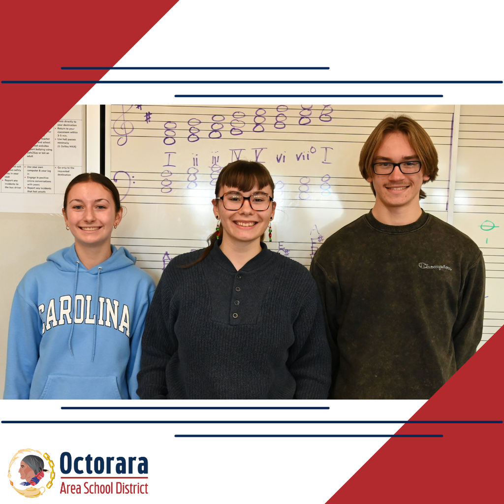 Three Octorara students stand side by side in a music classroom, smiling at the camera.
