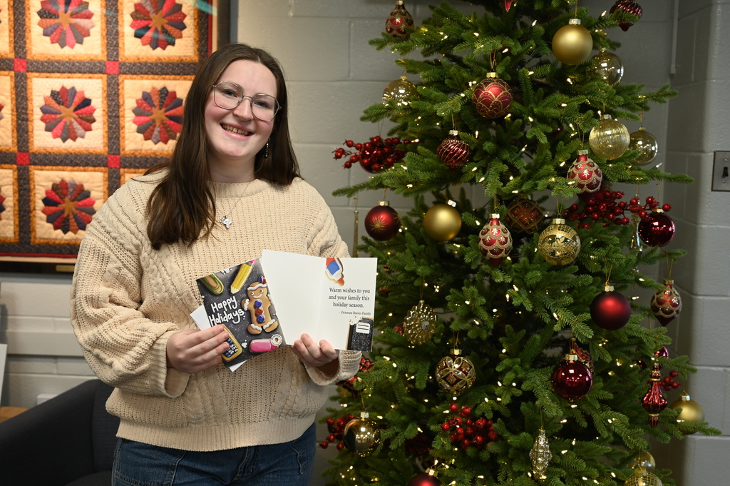 Mary Flowers presents her holiday card design; featuring school supplies as holiday cookies