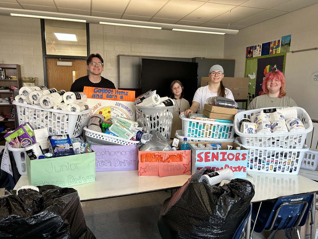 Students stand with items they collected to help support Good Samaritan Services.