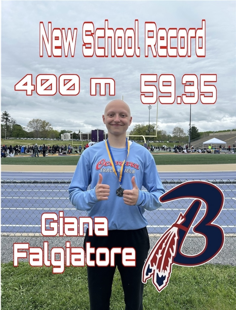student stands proudly after breaking the 400m school record