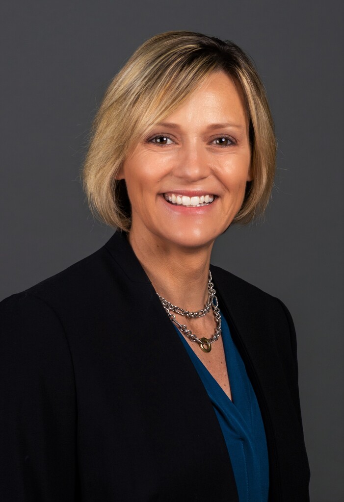 Woman in a black blazer smiling