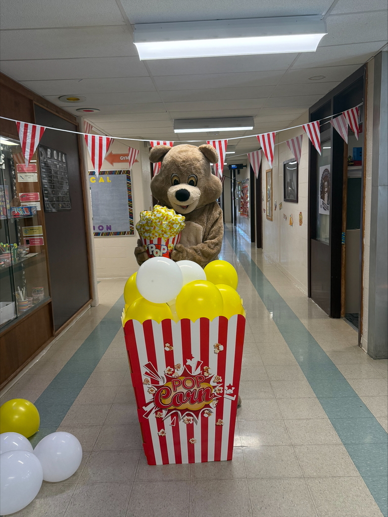 Grizzly handing out popcorn.