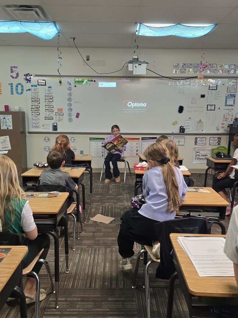 class listening to student read a book