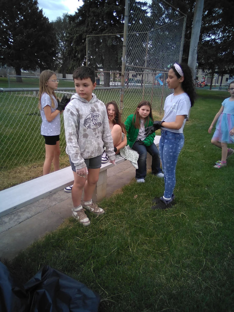 3rd grade students at park picking up trash