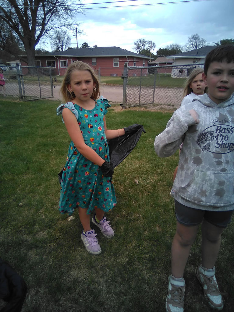 3rd grade students at park picking up trash