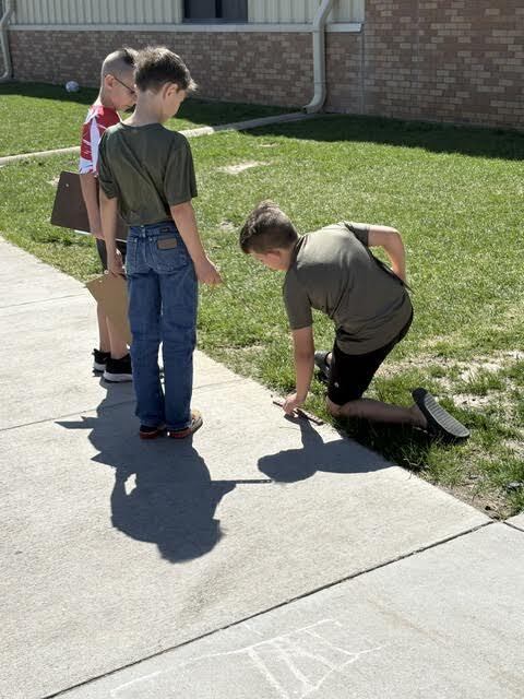 students doing a perimeter activity outdoors