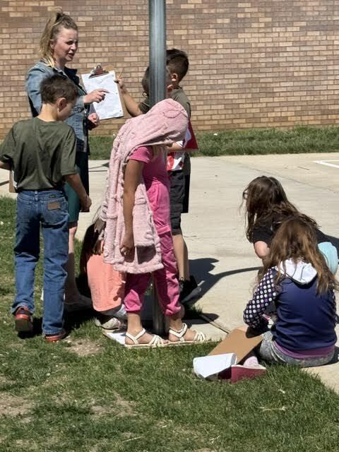 students doing a perimeter activity outdoors