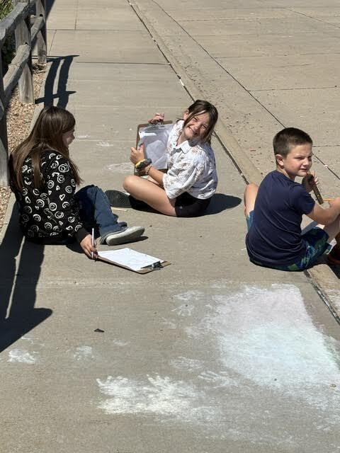 students doing a perimeter activity outdoors