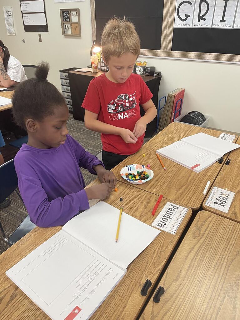 students counting linking cubes