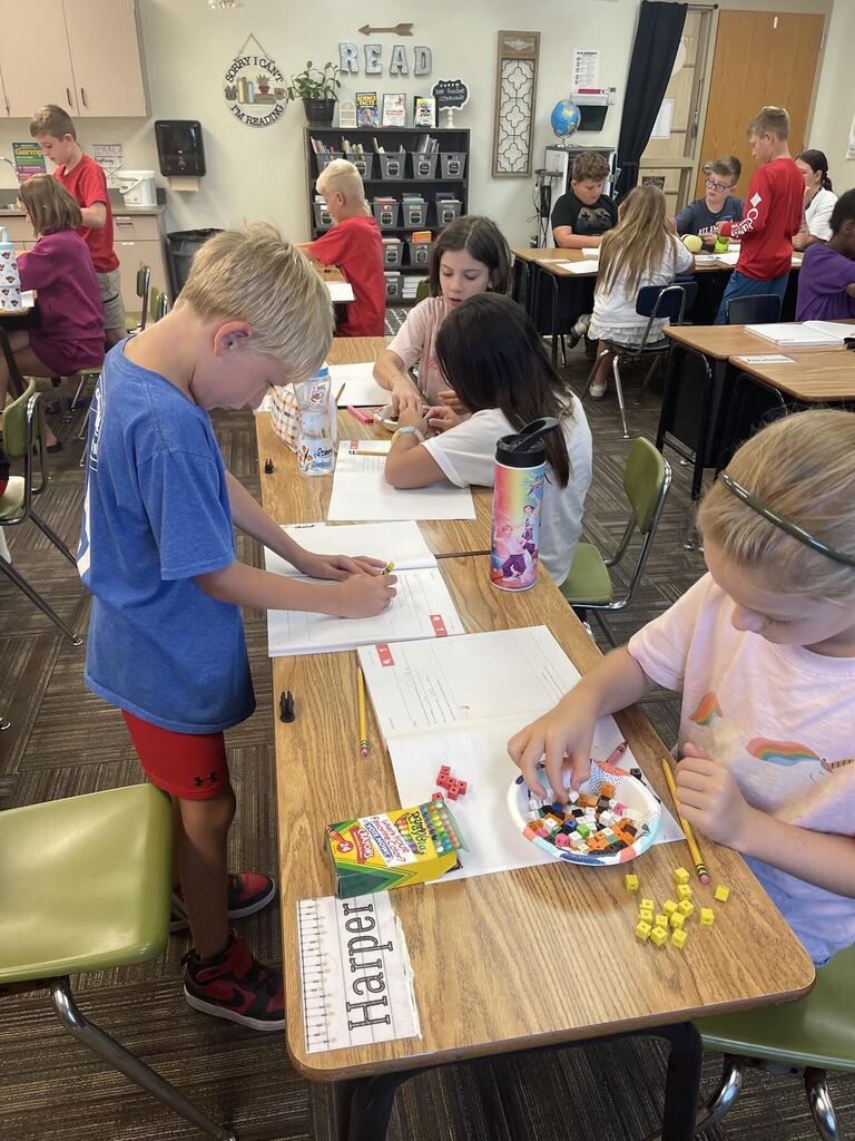 students counting linking cubes