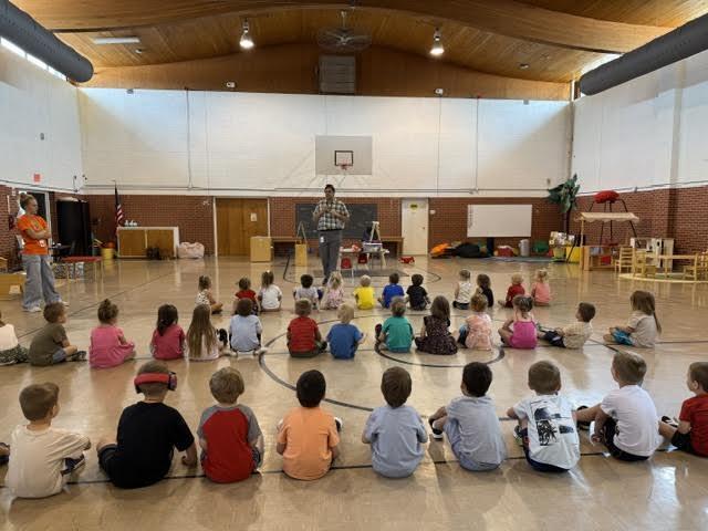 tiny trails students sitting in line listening to music teacher