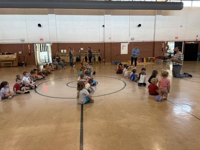 tiny trails students sitting in line listening to music teacher