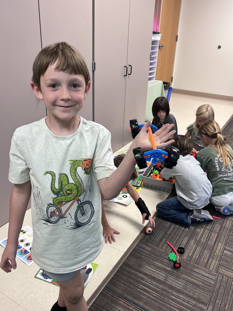 student holding kinex pieces