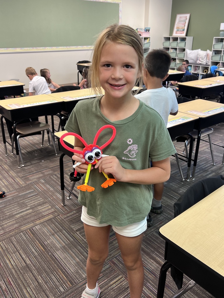 student holding kinex pieces