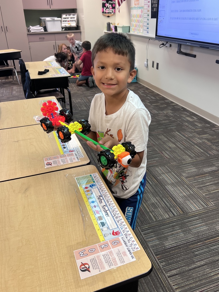 student holding kinex structure