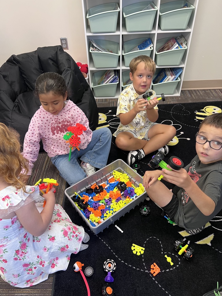 group of students around a box of kinex