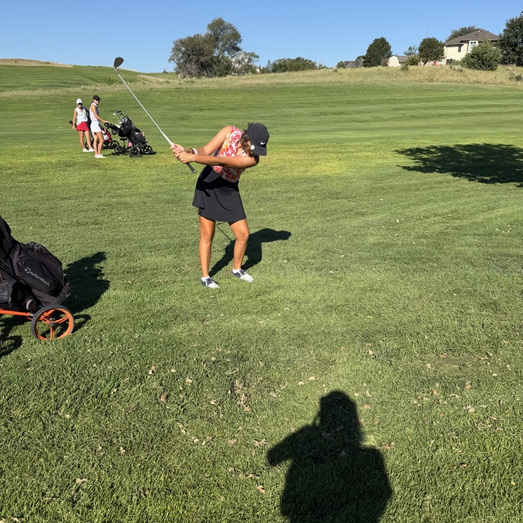 golfer swinging club 