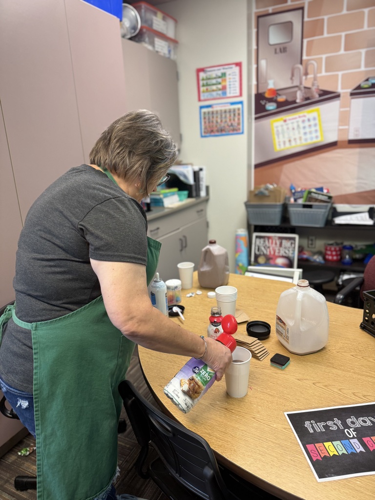 teaching at table making chocolate milk mixture